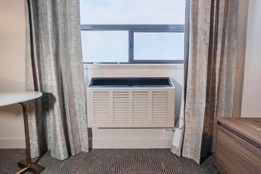A window with curtains and blinds in front of it.